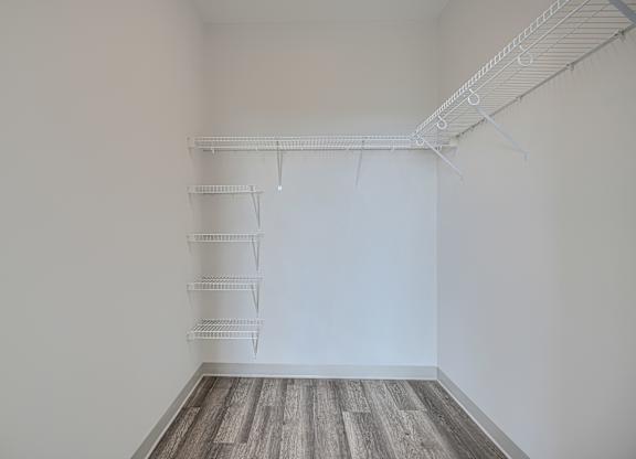 Empty room with white walls and a wooden floor.