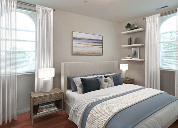 A bedroom with a large bed and a painting on the wall.