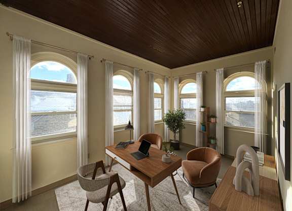 A room with a desk, chairs, and a television.