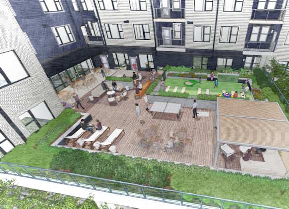 A rooftop garden with a seating area and a green lawn.