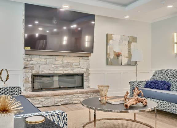 a living room with a fireplace and a table and chairs