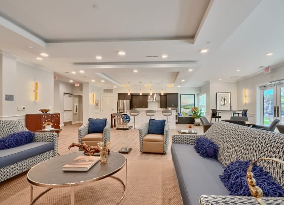 a large living room with couches and chairs and a table