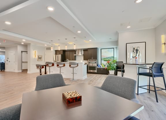 an open kitchen and living room with a table and chairs