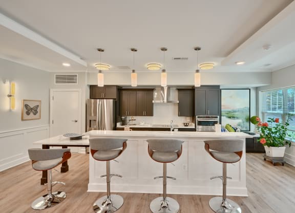 a kitchen with a large island with bar stools