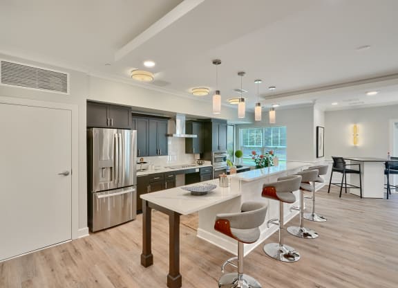an open kitchen and dining area with a bar and stools