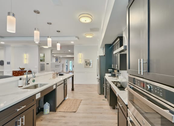 a large kitchen with stainless steel appliances and counters