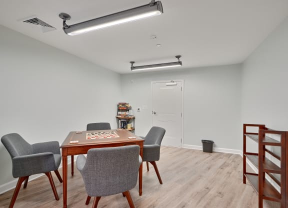 a room with a table with chairs and a game board