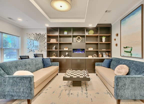 a living room with couches and a chess board