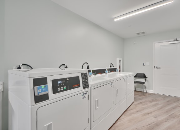 a laundry room with two washes and a sink in a building