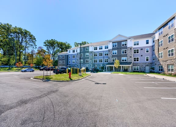 an empty parking lot in front of an apartment building