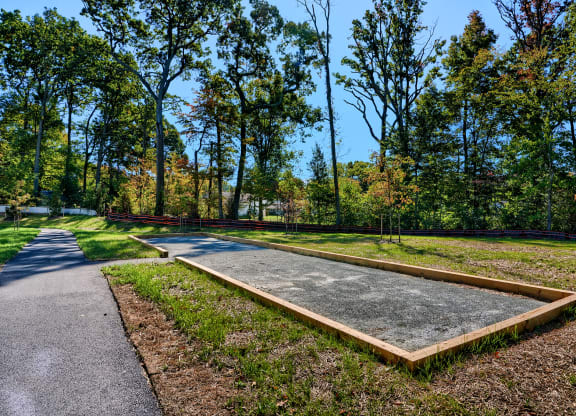 a park with a path and a raised concrete platform
