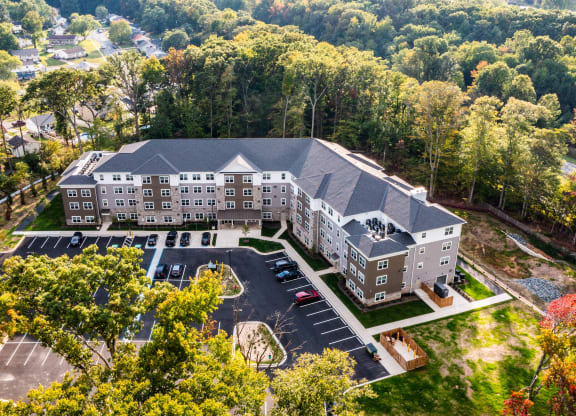 an aerial view of a large building surrounded by trees