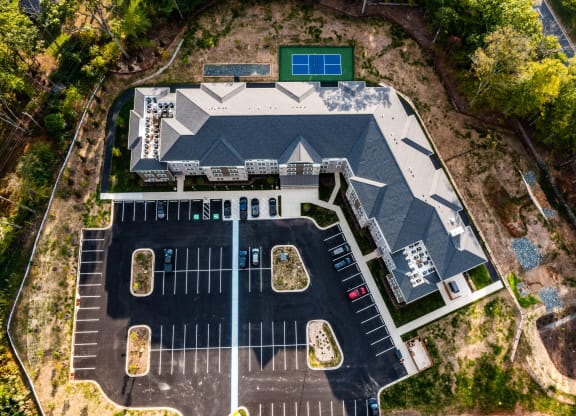 an aerial view of a house with a parking lot