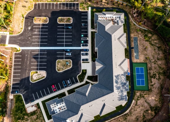 a birds eye view of a parking lot and a building