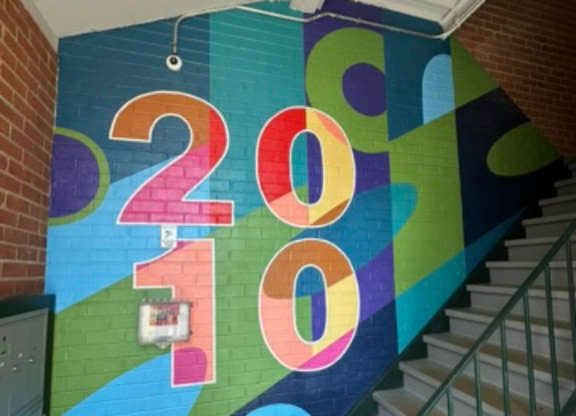 A staircase with a colorful 2010 sign on the wall.