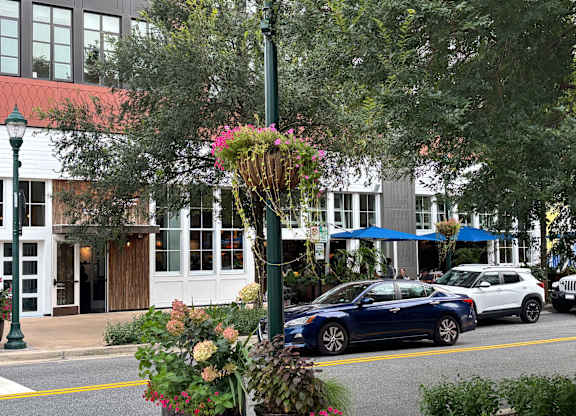A blue car is parked on the side of the street.