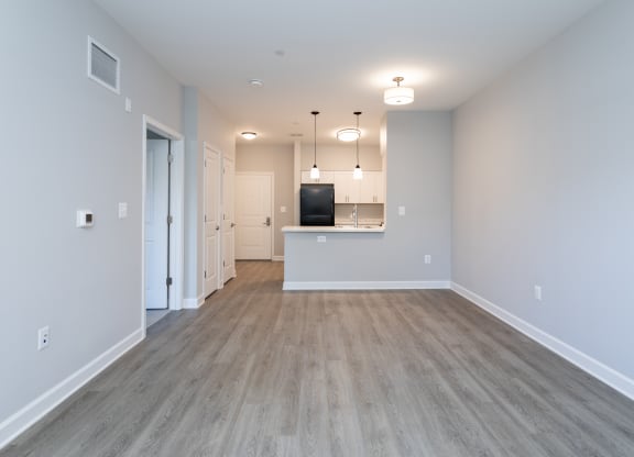 a spacious living room and kitchen in a new home