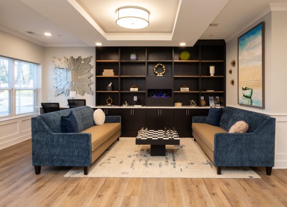 a living room with couches and a chess board