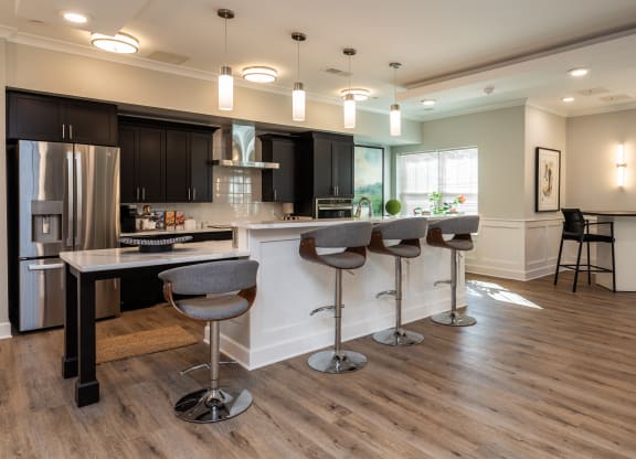 a kitchen with a large island with bar stools