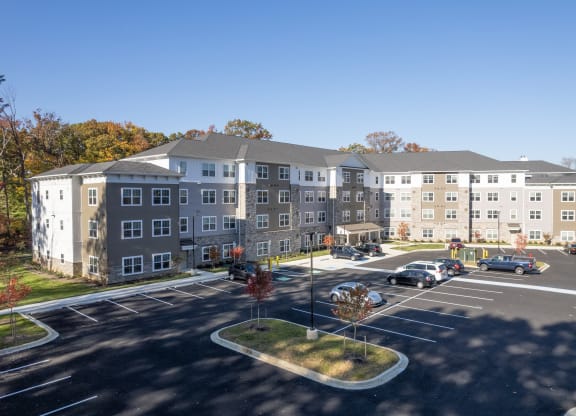 an aerial view of an apartment building in a parking lot