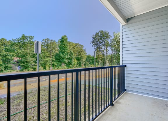 the view from the balcony of a house with a black railing