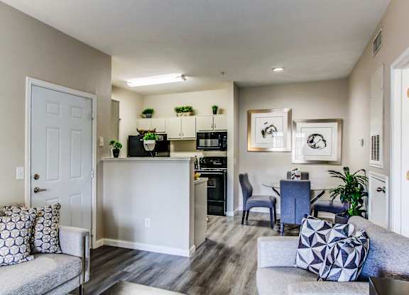 a living room and kitchen with a couch and a table