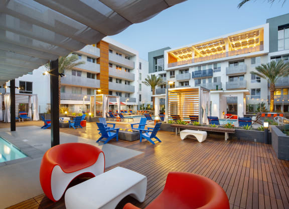 Woodland Hills, CA Luxury Apartments - The Q Variel - Sundeck with a Resort-Style Pool, a Heated Spa, Cabanas, Daybeds, and Fire Pits