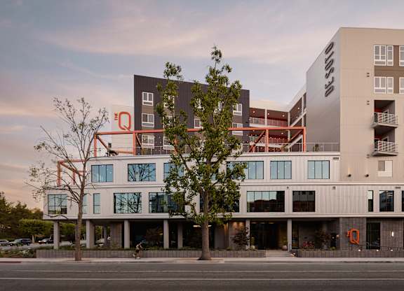 A modern building with a tree in front of it.