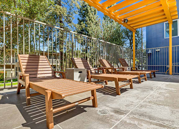 A sunny day at the outdoor seating area with wooden benches and tables.