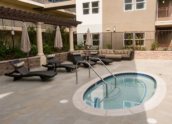 A small round pool with a ladder in the middle of it.