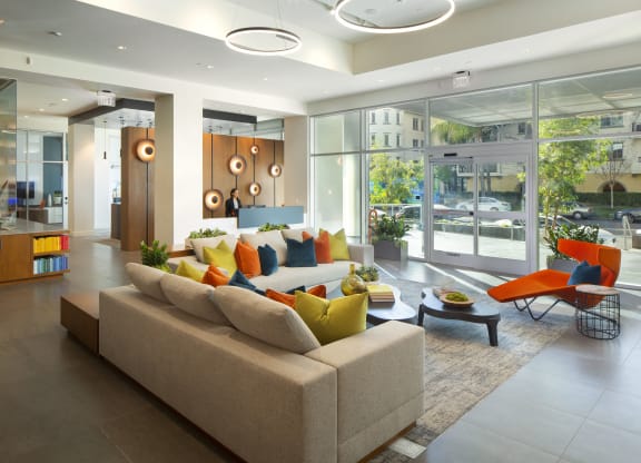 Apartments in Woodland Hills, CA - The Q Variel - Main Lobby With 24-Hour Concierge, Comfortable Seating, Modern Designs, and Secured Fob Access Sliding Doors