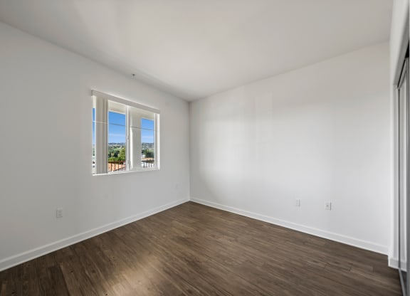 an empty room with white walls and a window