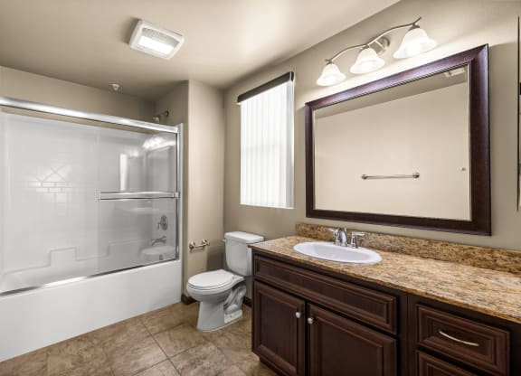 a bathroom with a shower toilet and sink and a mirror at Le Blanc Apartment Homes, California