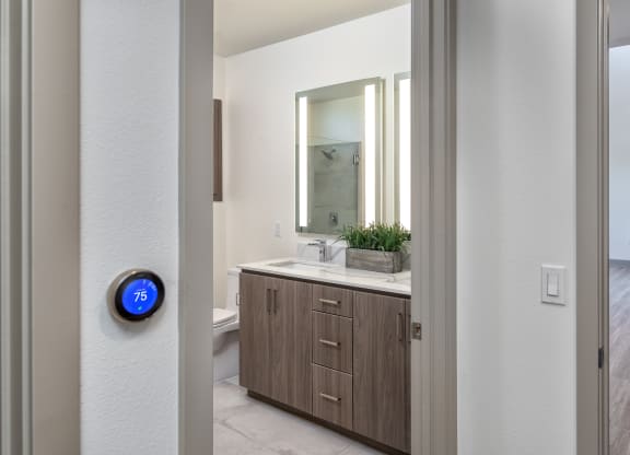an open door leading to a bathroom with a mirror and a sink