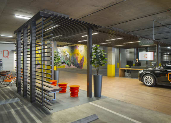 Studios in Woodland Hills, CA - The Q Variel Apartments - Complimentary Valet Parking with Seating, a Concierge, and an Electric Car Service Station