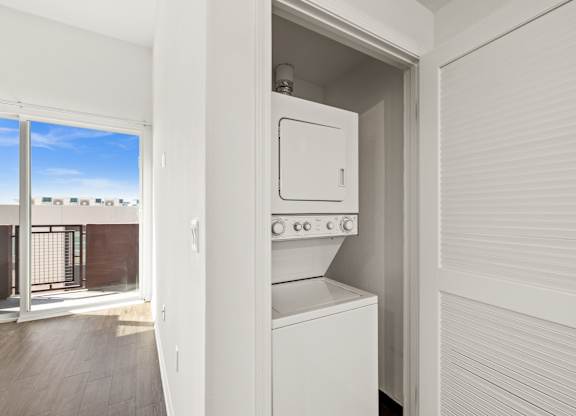 A white oven and microwave are built into a kitchen cabinet.
