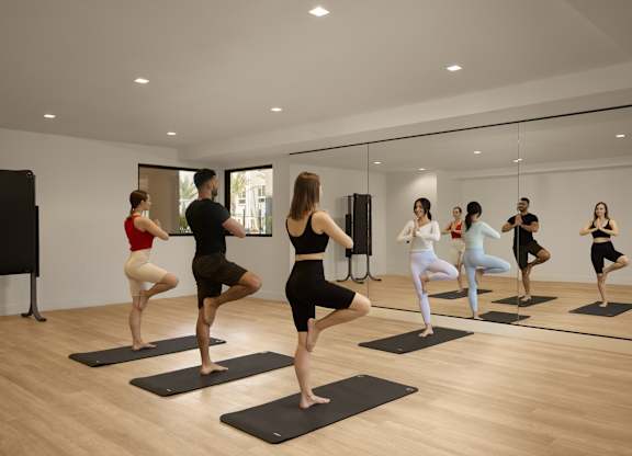 A group of people practicing yoga in a studio.
