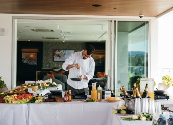 a man in a white shirt is preparing food on a table