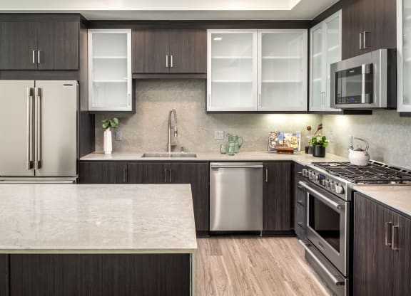 a kitchen with stainless steel appliances and marble counter tops