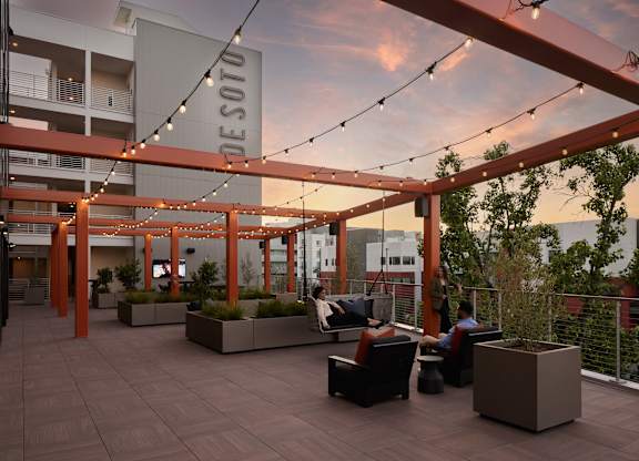 A Desoto sign is hanging from a pergola on a patio.