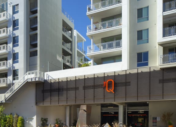 2 Bedroom Apartments in Woodland Hills, CA - The Q Variel - Property Exterior with a Parking Garage Entrance and Private Balconies
