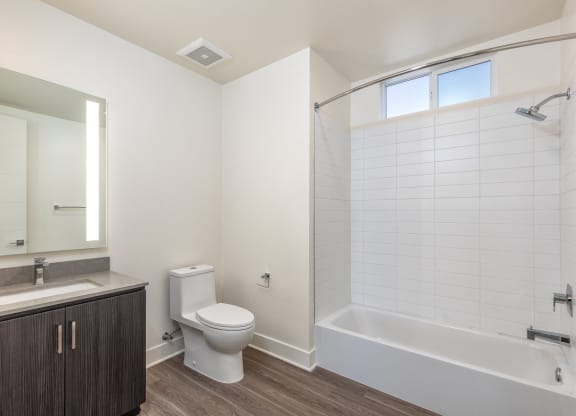 an empty bathroom with a toilet and a bath tub