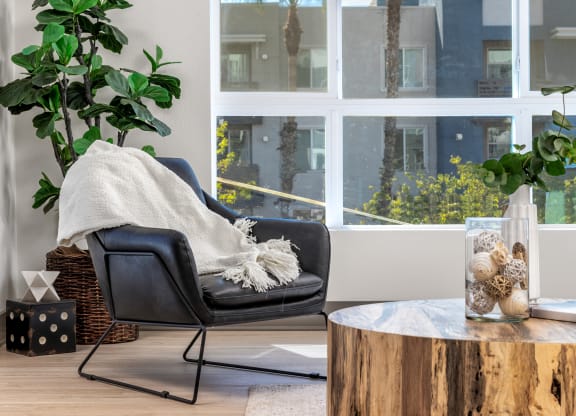 a living room with a chair and a coffee table