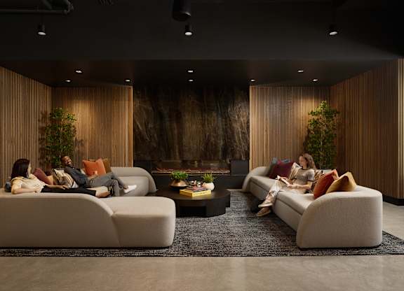 A modern living room with a large couch and a coffee table.