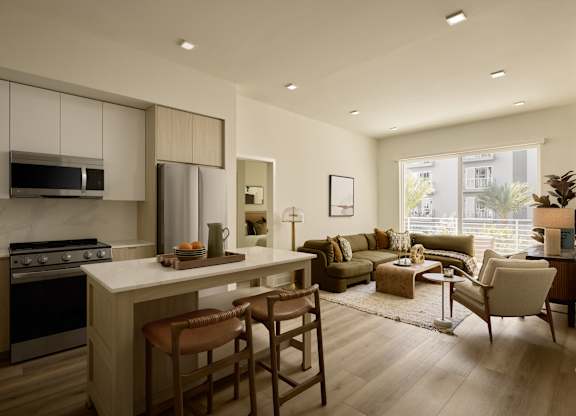 A modern kitchen with a dining area and a living room.