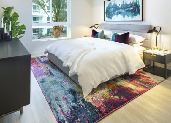 Woodland Hills, CA Pet-Friendly Apartments - The Q Variel - Bedroom with Luxury Wood Plank Style Flooring and an Oversized Window