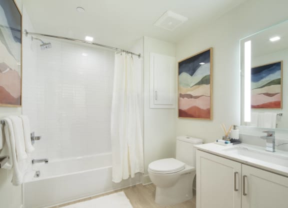 Woodland Hills, CA Luxury Apartments - The Q Variel - Bathroom with Luxury Vinyl Flooring, Spacious Bathtub, and Water Saving Fixtures