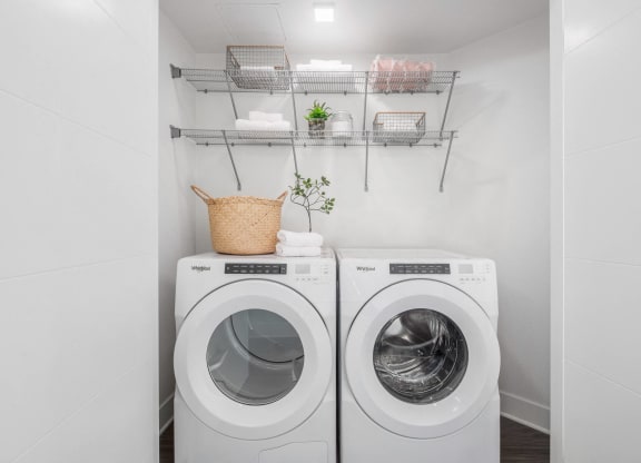 a washer and dryer in a laundry room with white walls