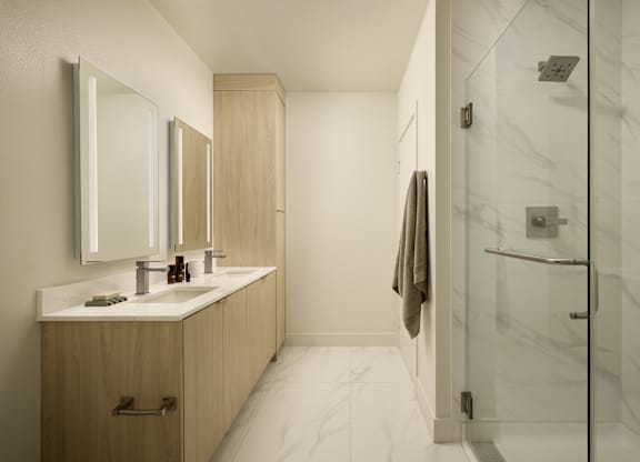 A bathroom with a marble floor and a wooden vanity.