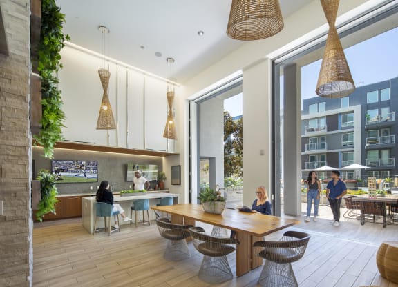 a rendering of a communal area with a dining table and chairs